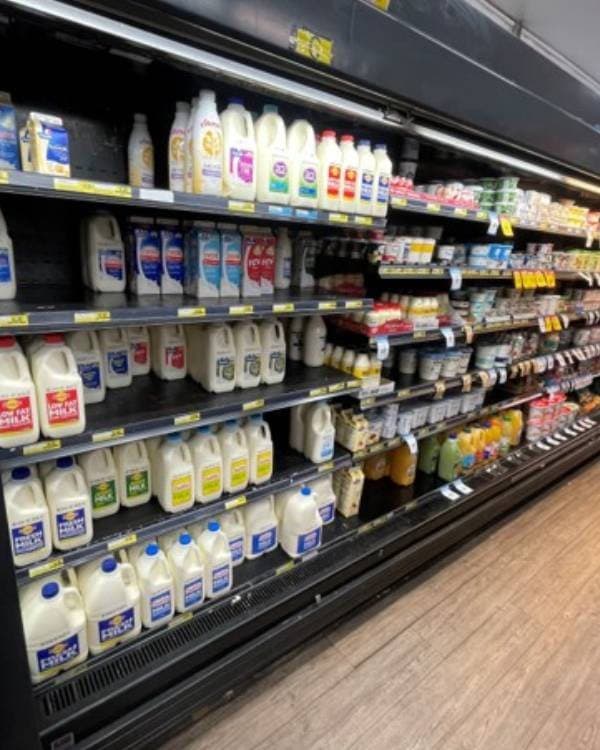 Open dairy case, supermarket aisle