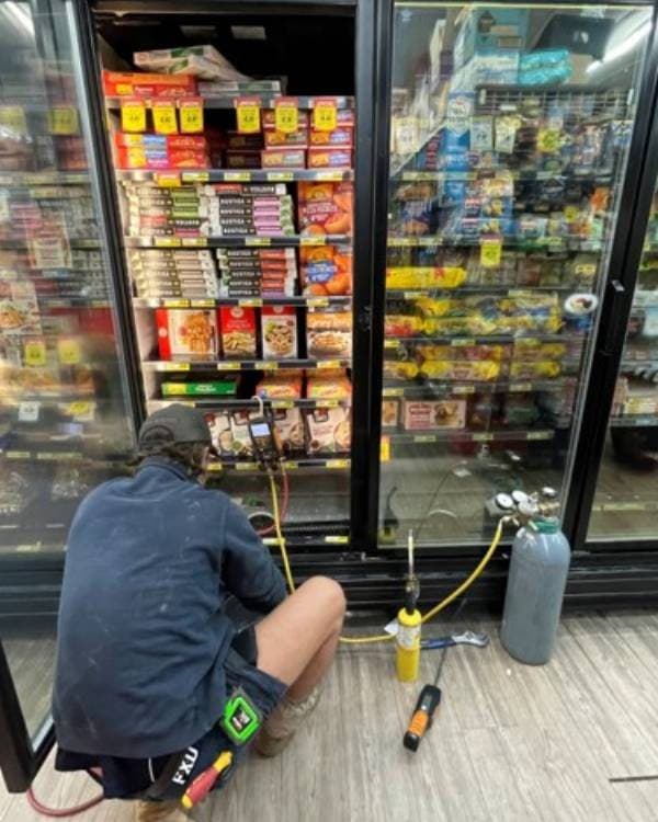 Servicing a supermarket display fridge