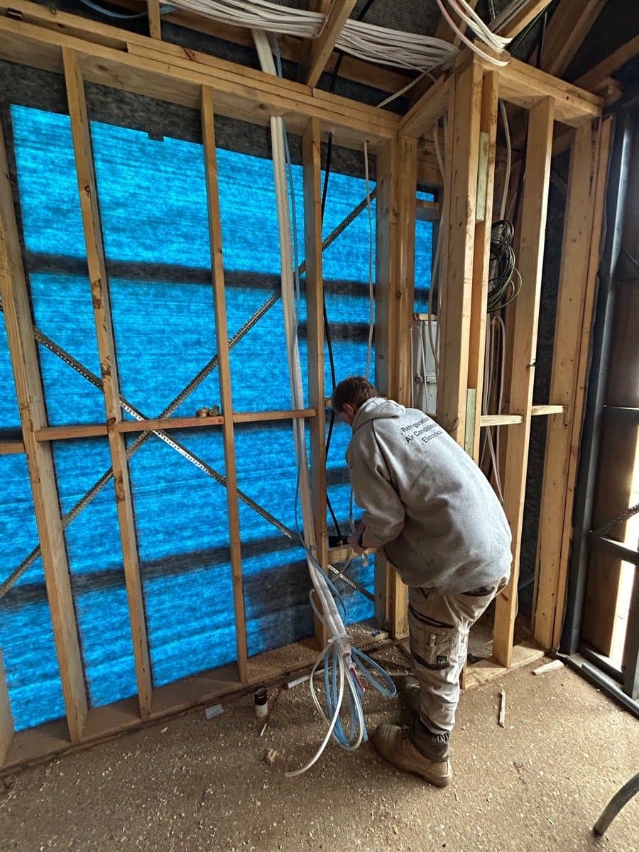 Running refrigerant and electrical through the stud wall
