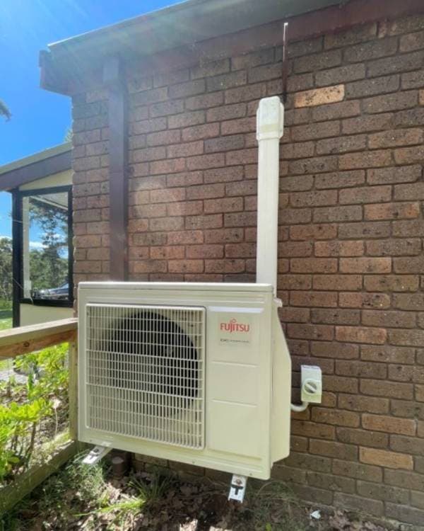 Split outdoor unit on a brick home